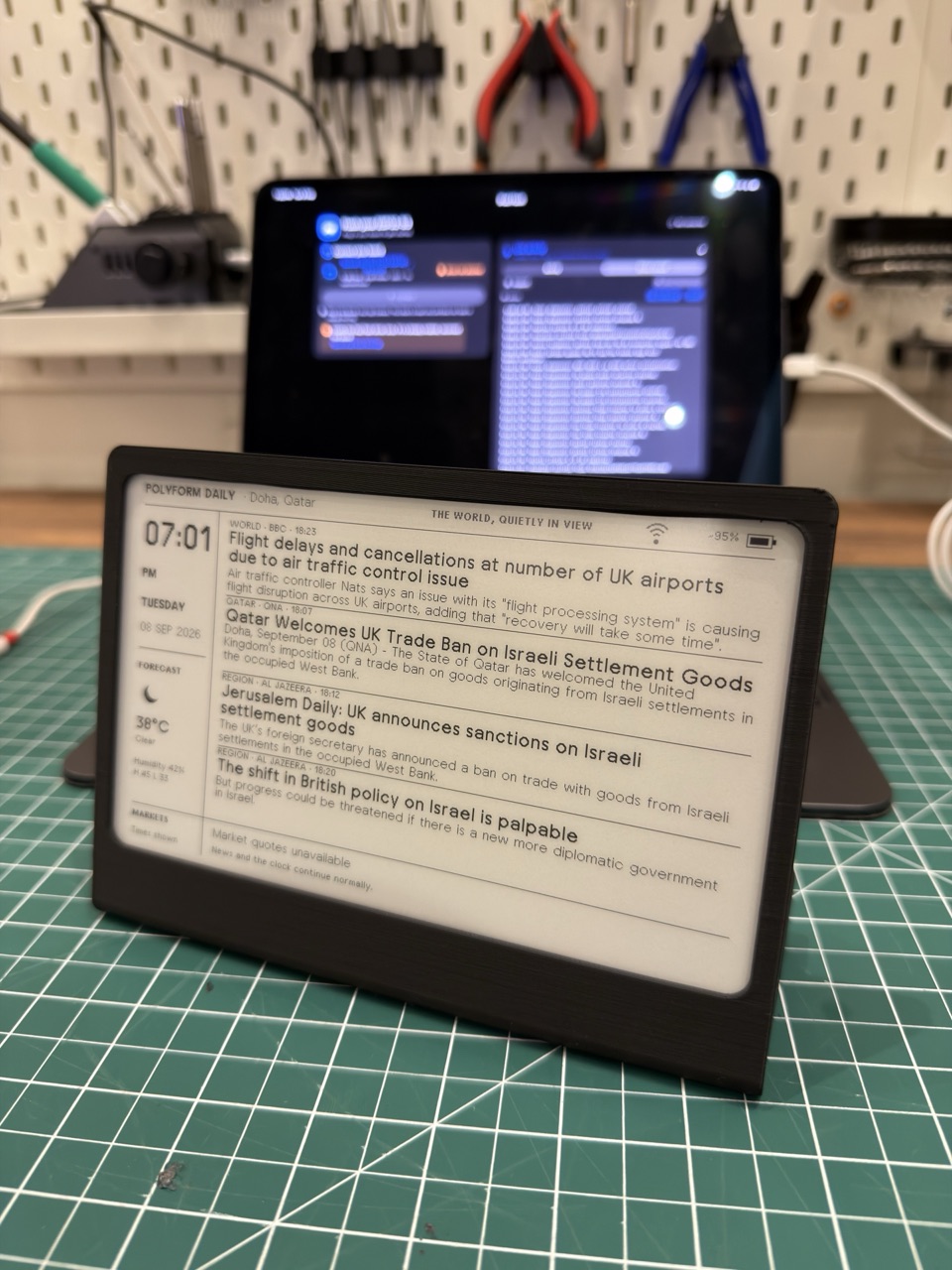 The POLYFORM Daily prototype on the workbench with development work on a tablet behind it